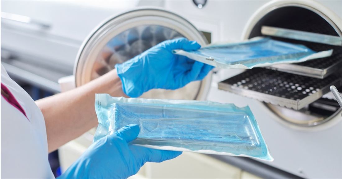 Packaged dental instruments being removed from an autoclave