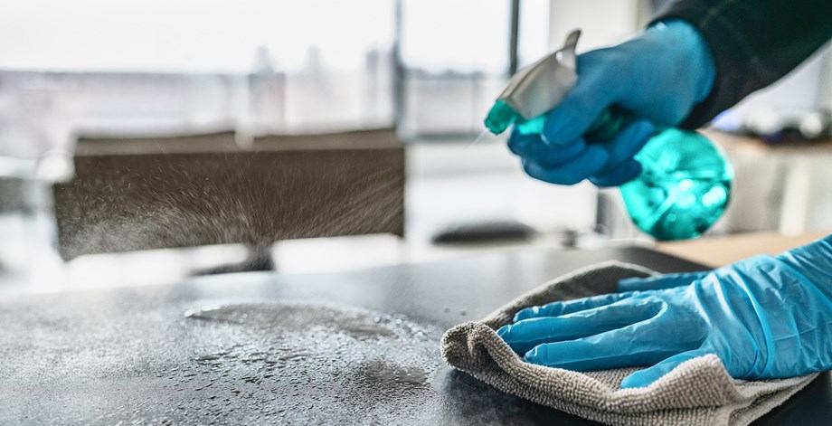 Surface being sprayed with disinfectant and wiped