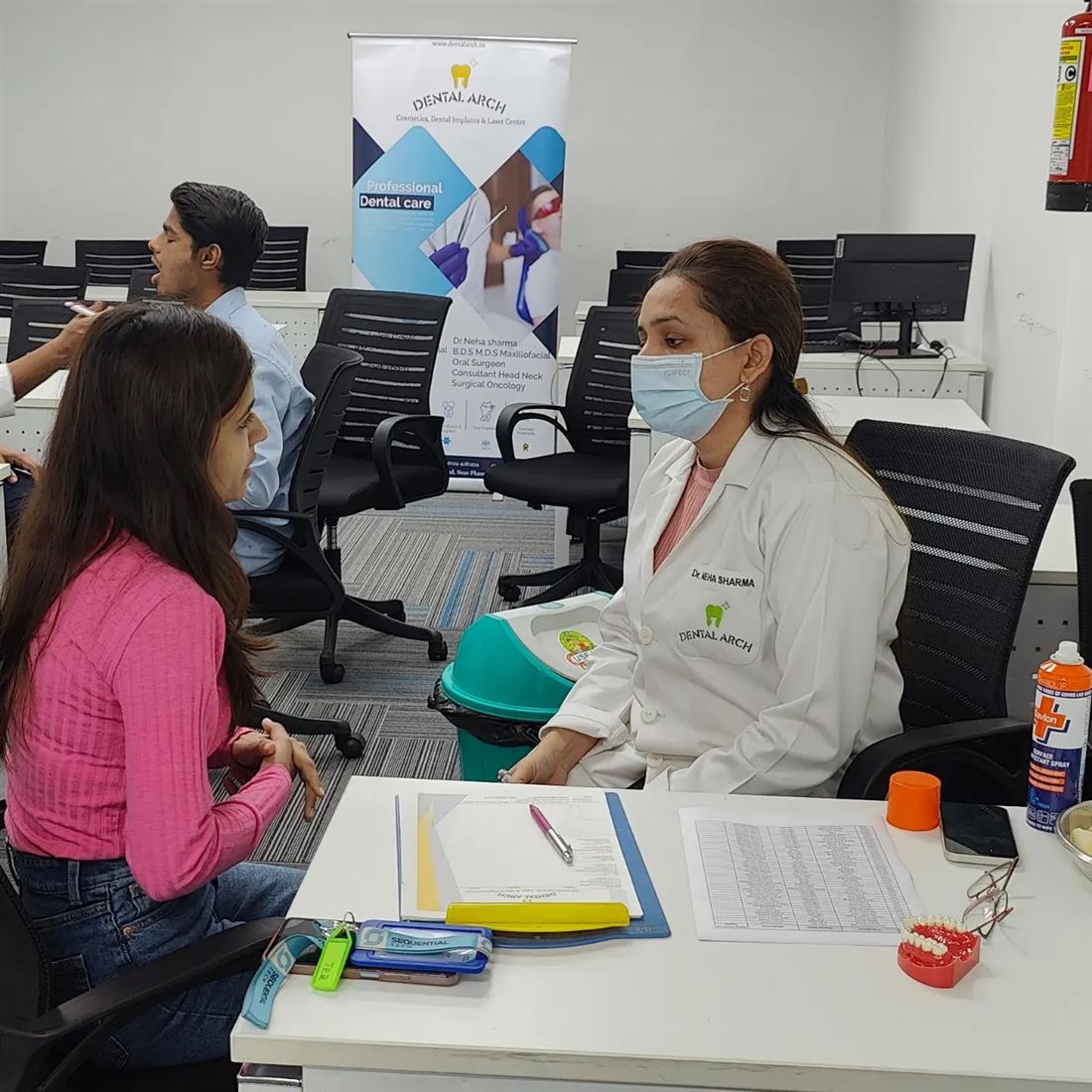 Dr. Neha Sharma screening an employee at a corporate dental camp in Gurgaon